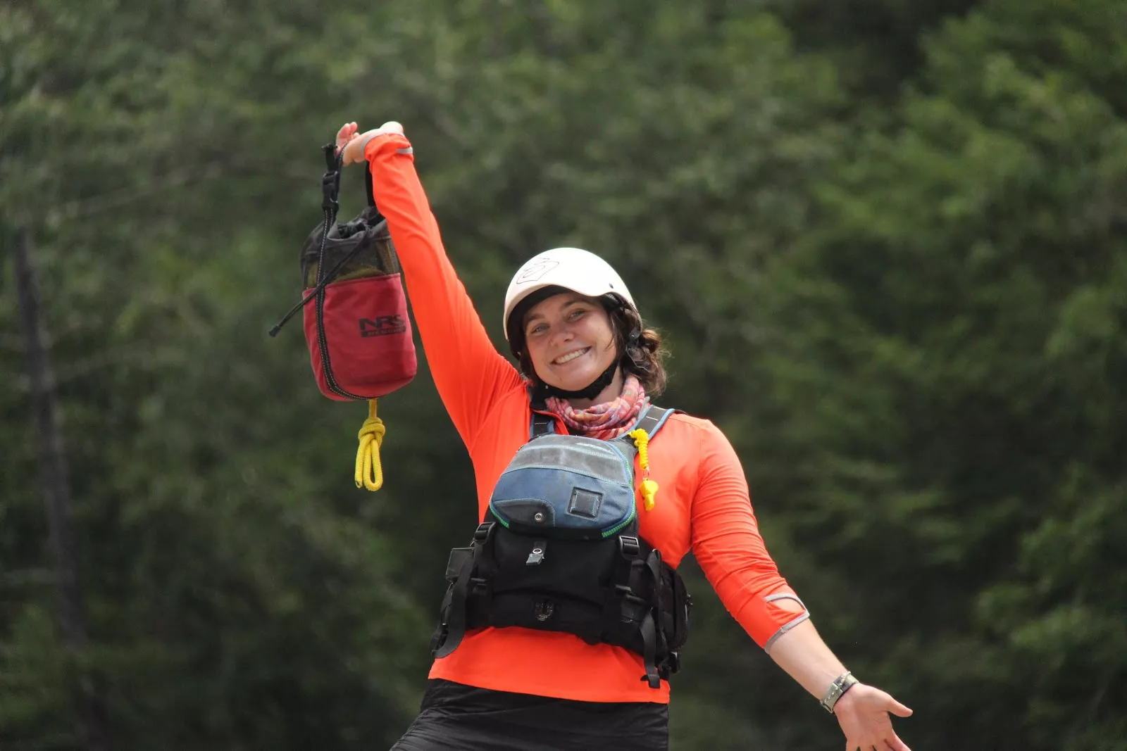 Woman smiling while standing in raft